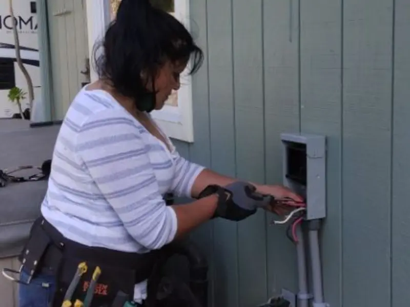 Licensed electrician wiring an exterior subpanel in Southwest Ranches